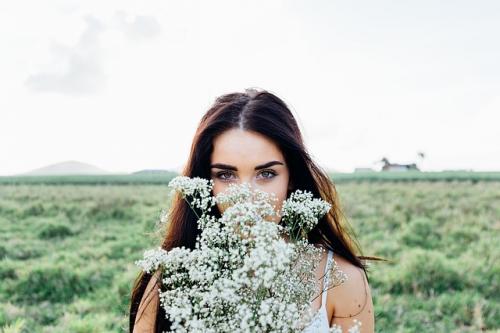 woman with flower practicing mindfulness